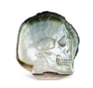 A CARVED BLACK-LIP OYSTER (PINCTADA MARGARITIFERA) MOTHER OF PEARL SHELL WITH SKULL