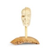 A CARVED ANTLER MEMENTO MORI OF A MAN'S HEAD AND SKULL