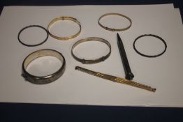 A HALLMARKED SILVER BANGLE TOGETHER WITH WHITE METAL AND ROLLED GOLD EXAMPLE