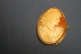 A CARVED SHELL CAMEO IN YELLOW METAL MOUNT