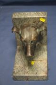A BRONZE SCULPTURE OF A DOGS HEAD MOUNTED ON A MARBLE STAND
