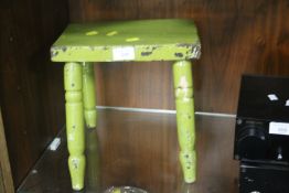AN ANTIQUE PAINTED WODEN STOOL WITH TURNED LEGS