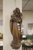 A CARVED WALL HANGING OF MADONNA AND CHILD