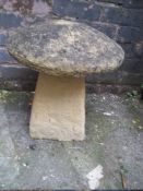 A CONCRETE GARDEN MUSHROOM FOUNTAIN