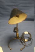 AN UNUSUAL VINTAGE COMBINATION TABLE LAMP/ WALL LIGHT WITH PAINTED METAL SHADE AND BRASS BASE