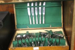 AN OAK CASED CANTEEN OF STAINLESS STEEL CUTLERY