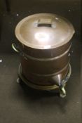 A LARGE COPPER TEA URN ON CAST IRON STAND