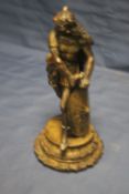 A HEAVY BRASS FIGURE