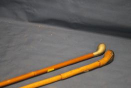 TWO ANTIQUE SUNDAY GOLF CLUB STYLE WALKING STICKS ONE WITH SILVER MOUNTS (2)