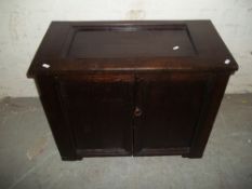 AN ANTIQUE SOLID OAK 2 DOOR CUPBOARD