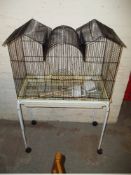 A BIRD CAGE AND STAND