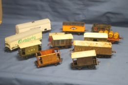 TWELVE CARRIAGES AND ROLLING STOCK, to include tin plate and plastic examples (Boxes and trays not