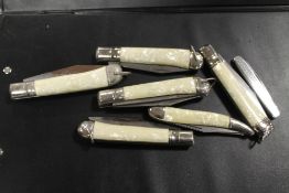 A BAG OF SIX POCKET KNIVES