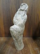 A VINTAGE STONE STATUE OF A WOMAN