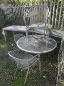 A MODERN CIRCULAR METAL PATIO TABLE AND FOUR CHAIRS