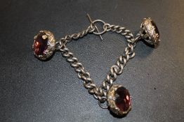 A HALLMARKED SILVER ALBERT STYLE CHAIN WITH THREE MODERN BASE METAL CHARMS