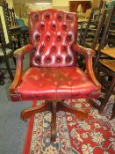 AN OXBLOOD RED SWIVEL OFFICE CHAIR A/F