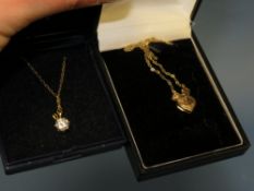 A YELLOW METAL HEART SHAPED LOCKET ON 9CT GOLD CHAIN TOGETHER WITH A GILT SILVER PENDANT NECKLACE (