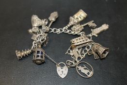 A VINTAGE SILVER CHARM BRACELET WITH LARGE CHARMS