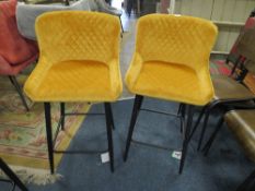 A PAIR OF MODERN MUSTARD UPHOLSTERED KITCHEN STOOLS