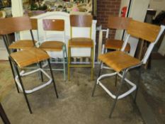 A HARLEQUIN SET OF SIX INDUSTRIAL STYLE METAL BAR STOOLS