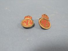 TWO NUMBERED A.F.S. SILVER BADGES