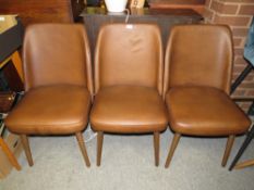 THREE MODERN BROWN LEATHER STYLE CHAIRS