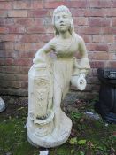 A CONCRETE GARDEN FIGURE OF A WATER CARRIER - H 72 CM