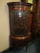 A QUALITY REPRODUCTION MAHOGANY BOWED FLOORSTANDING CORNER CABINET