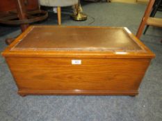 AN OAK BOX WITH UPHOLSTERED TOP - W 64 CM
