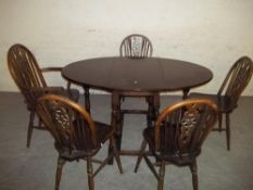 AN OAK REPRODUCTION DINING SET