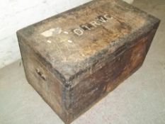 AN ANTIQUE WOODEN TRAVEL TRUNK WITH METAL LINING