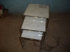 A MODERN GLASS AND CHROME NEST OF 3 TABLES