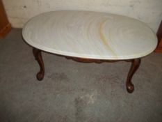A MARBLE TOPPED COFFEE TABLE