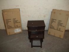 AN OAK FINISH NEST OF THREE TABLES AND 2 BOXED FOLDING TABLES
