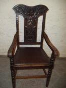 AN ANTIQUE OAK CARVED GRANDFATHER STYLE CHAIR