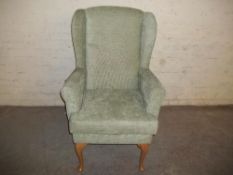 A HIGH SEATED FIRESIDE CHAIR