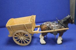 A CERAMIC HORSE AND WOODEN CART
