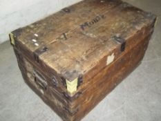AN ANTIQUE WOODEN TRAVEL TRUNK