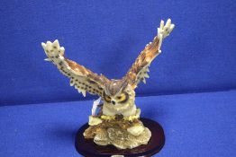 A CERAMIC SCULPTURE OF AN OWL