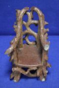 AN ANTIQUE MINIATURE RUSTIC SALT GLAZED CHAIR DATED 1899 A/F
