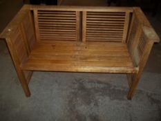 A MODERN WOODEN GARDEN BENCH