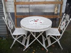 A IRON GARDEN SET INCLUDING A TABLE AND 2 CHAIRS