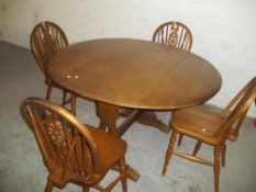 A MODERN OAK DROP LEAF TABLE/DINING SET WITH 4 WHEEL BACK CHAIRS
