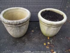 A PAIR OF RECONSTITUTED STONE LARGE GARDEN PLANTERS,br.