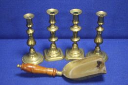 FOUR BRASS CANDLES AND A SHOVEL