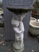 A CONCRETE BIRD BATH, PLANTER DEPICTING A BOY HOLDING A FISH
