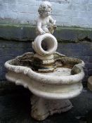 A RECONSTITUTED STONE WATER FOUNTAIN