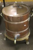 A LARGE COPPER TEA URN ON CAST IRON STAND