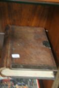 AN ANTIQUE LEATHER BOUND LEDGER WITH BRASS LOCK